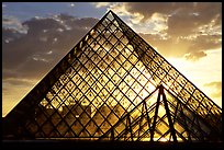 Sunset and clouds seen through Pyramid, the Louvre. Paris, France (color)