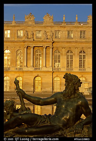 Statue, basin, and Versailles palace facade, late afternoon. France (color)