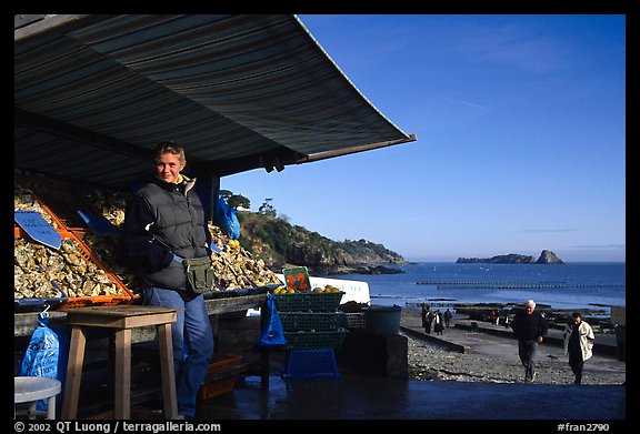 Oyster stand and vendor in Cancale. Cancale oysters are reknown in France. Brittany, France