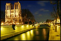 Facade of Notre Dame and Seine river at night. Paris, France (color)