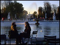 Couple sitting by basin in Tuileries Gardens. Paris, France ( color)
