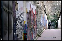 Boy in side alley with graffiti on walls. Paris, France (color)
