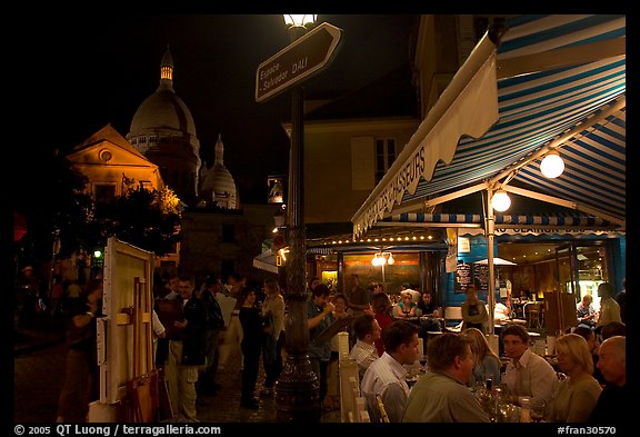 Outdoor dining at night on the Place du Tertre, Montmartre. Paris, France