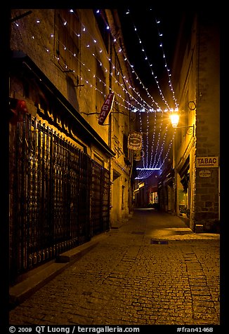 Lonely street by night with Tabac sign and Christmas lights. Carcassonne, France