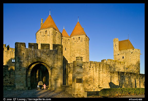 Main entrance of medieval city  with child and adult walking in. Carcassonne, France (color)