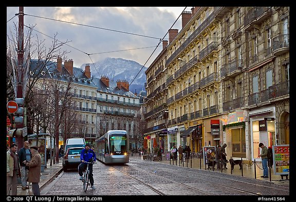 Bicyclist and tramway next to Victor Hugo place. Grenoble, France
