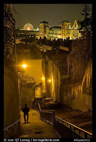 Man walking down stairs from Fourviere Hill, with St-Jean Cathedral below. Lyon, France (color)
