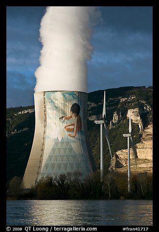 Cooling tower of nuclear power plant with ecology-themed art by Jean-Marie Pierret, and windmill. Provence, France (color)
