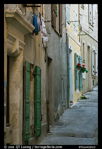 Painted facades in narrow street. Arles, Provence, France