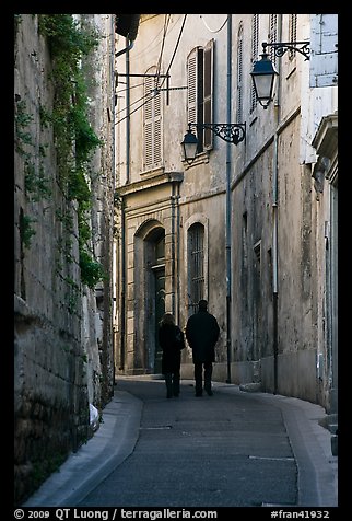 Couple walking in old street. Arles, Provence, France (color)