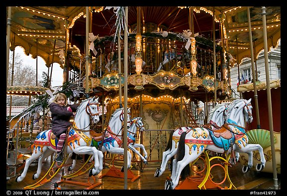 Girl on merry-go-round. Avignon, Provence, France