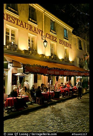 Restaurant with outdoor sitting by night, Montmartre. Paris, France