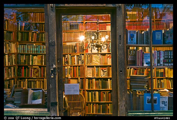 Books on shelves seen through storefront. Quartier Latin, Paris, France (color)