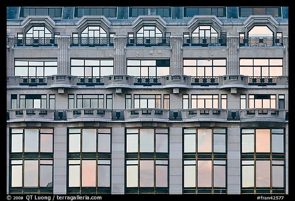 Glass windows of the Samaritaine reflecting colors of sunset. Paris, France