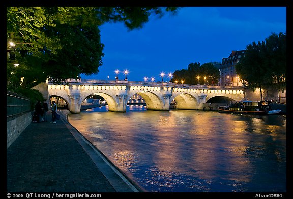 Quay, Seine River, and Pont-Neuf at night. Paris, France
