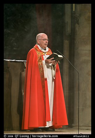 Cardinal of catholic church reading in Notre-Dame. Paris, France