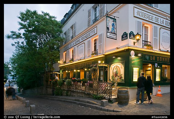 Couple looking at menu outside restaurant, Montmartre. Paris, France