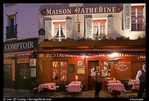 Restaurant and waiter at night, Montmartre. Paris, France