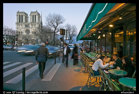 Cafe, street, and Notre Dame at dusk. Quartier Latin, Paris, France