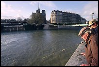 Fishermen on ile Saint Louis, with ile de la Cite in the background. Paris, France (color)