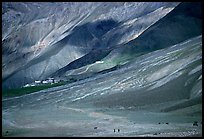 Barren hills with figures walking towards Karsha monastery, Zanskar, Jammu and Kashmir. India ( color)