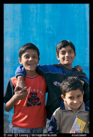 Young boys in front of blue wall. Jodhpur, Rajasthan, India (color)