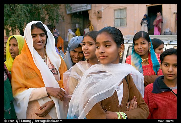 Women standing in the street during a wedding. Jodhpur, Rajasthan, India