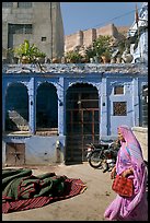 Woman in sari, blue house, and fort in the distance. Jodhpur, Rajasthan, India ( color)