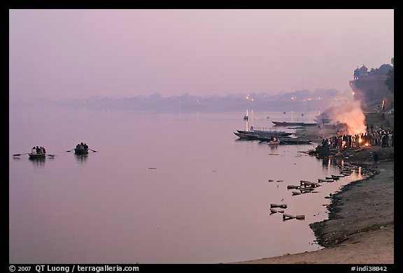 Ganges River at sunset with cremation fire. Varanasi, Uttar Pradesh, India (color)
