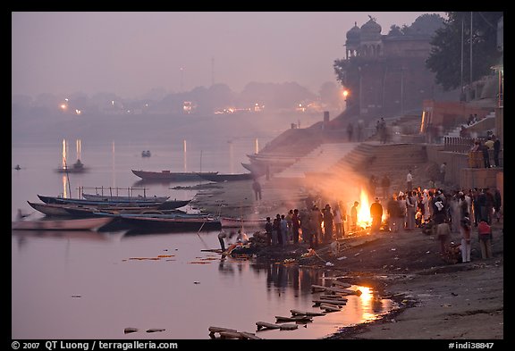 Cremation fire on banks of Ganges River. Varanasi, Uttar Pradesh, India (color)