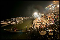Boat and Dasaswamedh Ghat at the start of evening puja. Varanasi, Uttar Pradesh, India (color)