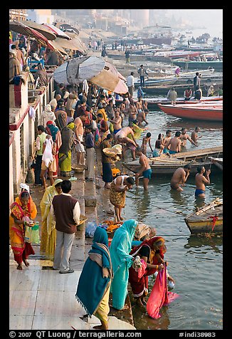 Gathering on the banks of Ganges River, sunrise. Varanasi, Uttar Pradesh, India (color)