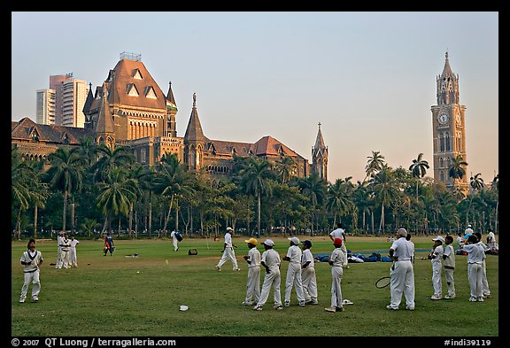 Boys in cricket attire on Oval Maidan, High Court, and Rajabai Tower. Mumbai, Maharashtra, India (color)