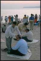 Head rub given by malish-wallah, Chowpatty Beach. Mumbai, Maharashtra, India