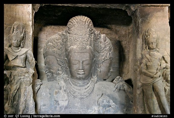 Trimurti flanked by pilasters with figures of dwarplalas, Elephanta caves. Mumbai, Maharashtra, India (color)