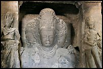 Trimurti flanked by pilasters with figures of dwarplalas, Elephanta caves. Mumbai, Maharashtra, India (color)