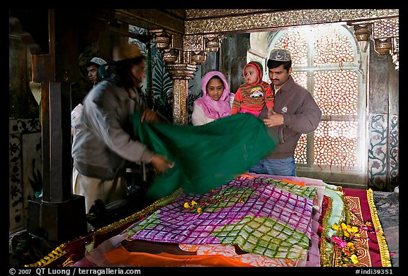 Family making offering inside Shaikh Salim Chishti mausoleum. Fatehpur Sikri, Uttar Pradesh, India (color)