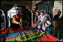 Women making offerings on Shaikh Salim Chishti tomb. Fatehpur Sikri, Uttar Pradesh, India (color)