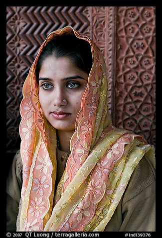 Young woman with embroided scarf, in front of Rumi Sultana wall. Fatehpur Sikri, Uttar Pradesh, India (color)