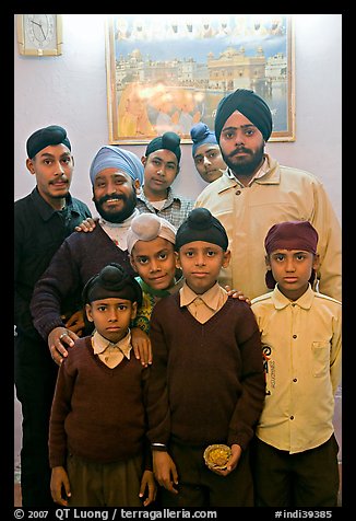 Sikh men and boys in front of picture of the Golden Temple. Bharatpur, Rajasthan, India (color)