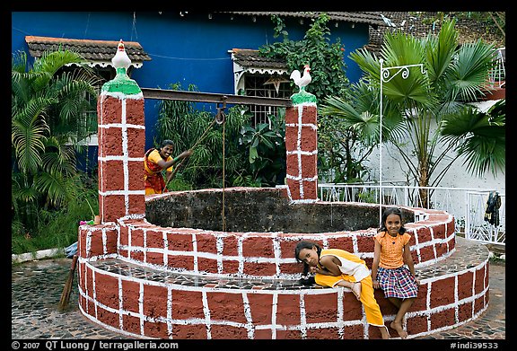 Woman and girls at communal well, Panjim. Goa, India (color)
