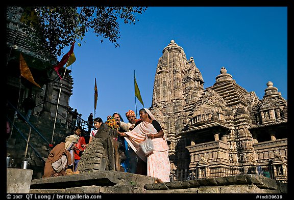 Worshippers making offering at Matangesvara temple with  Lakshmana behind. Khajuraho, Madhya Pradesh, India