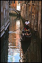 Gondola and reflections in a narrow canal. Venice, Veneto, Italy (color)