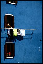 Windows, hanging laundry, blue house, Burano. Venice, Veneto, Italy