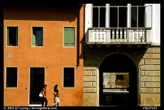 House facades with women walking. Veneto, Italy