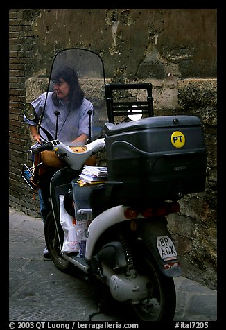 Delivering mail from a scooter. Siena, Tuscany, Italy (color)