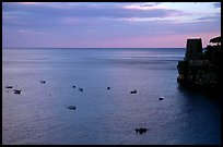 Small boats and tower and sunset, Positano. Amalfi Coast, Campania, Italy