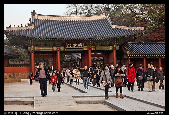 People walking down gate, Changdeok Palace. Seoul, South Korea (color)