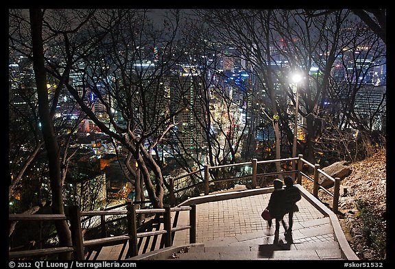 Couple walking down Namsan stairs by night. Seoul, South Korea