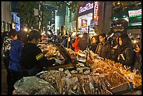 Unusual street foods on busy shopping street. Seoul, South Korea ( color)